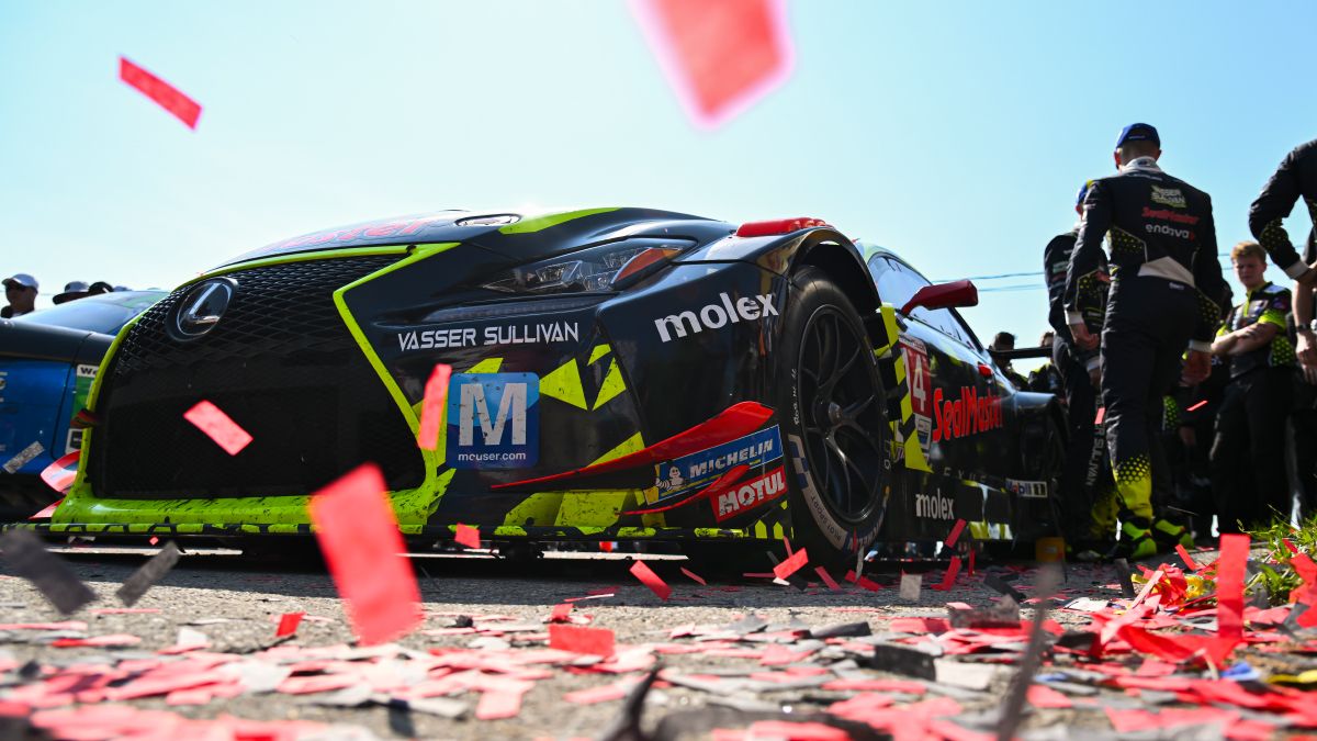Profile of GT3 racecar in front of a Lexus Racing banner.