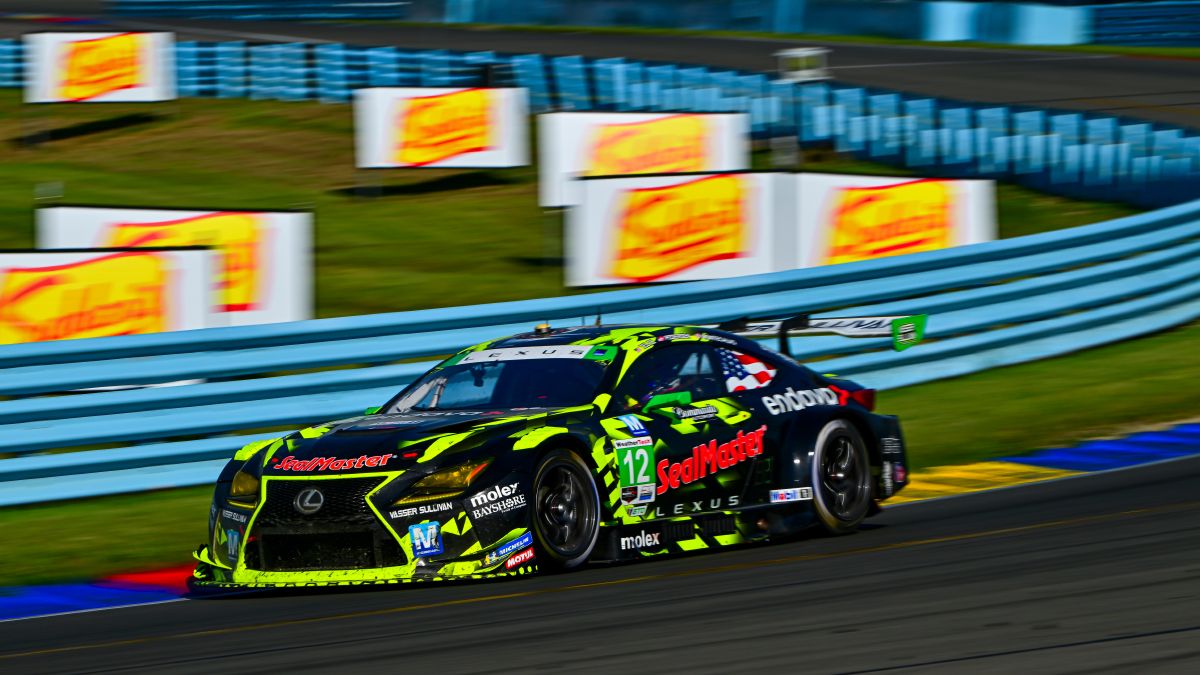 Lexus GT3 racecars at the high side of a turn on the racetrack.