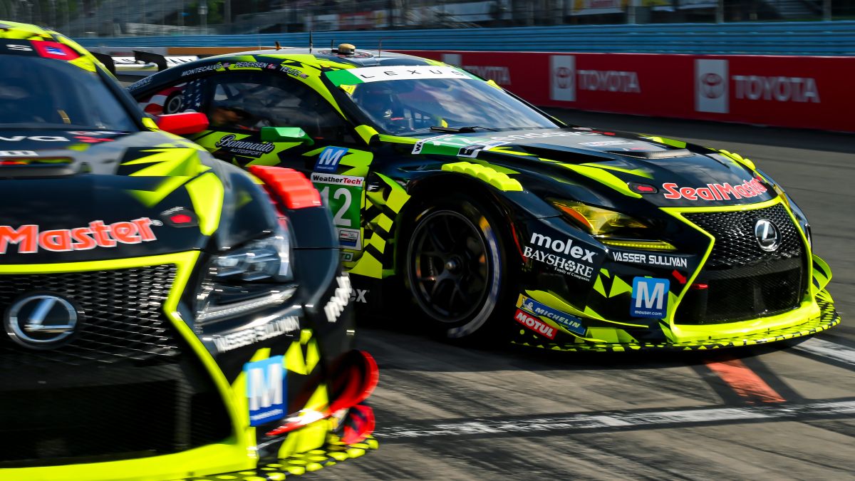Lexus GT3 car gets a fresh set of tires in the pit.