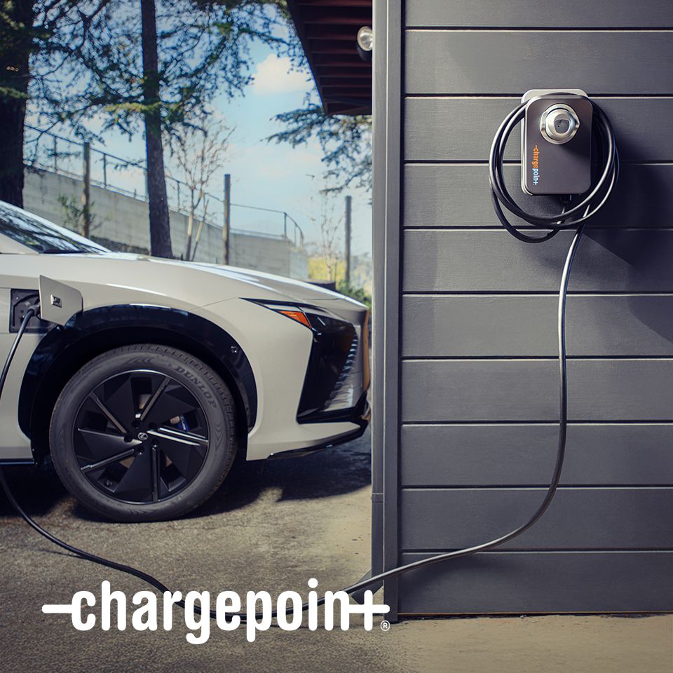 An electric car plugged into an IONNA charging station.