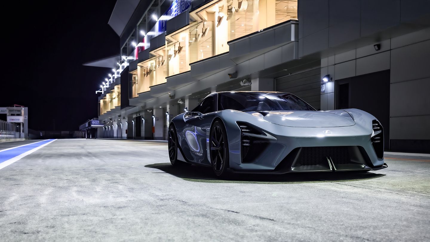 Rear view of LFA Concept with glowing red LED taillamps and illuminated brand lettering.