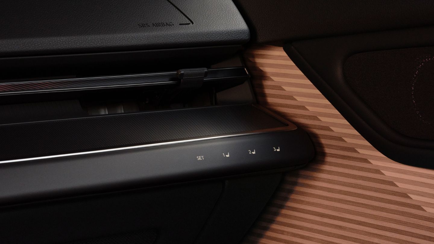 Close-up of Bamboo Layering trim and seat preset button for front passenger.