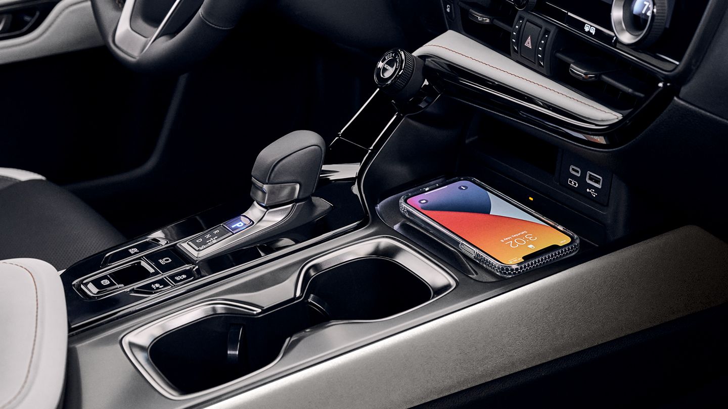 Close-up of center console with Macadamia leather and Black Open-Pore Wood trim.